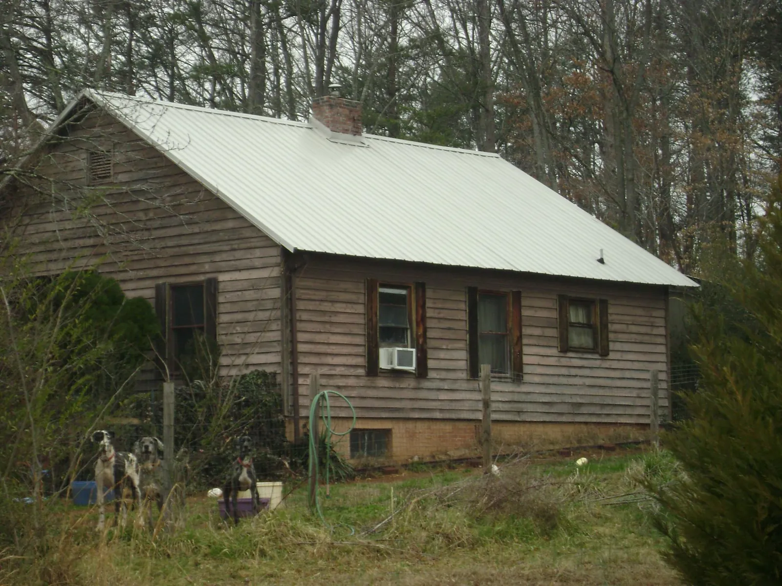 White metal roof on an old wood sided farmhouse, from a Metal Roof Installation job in Circleville